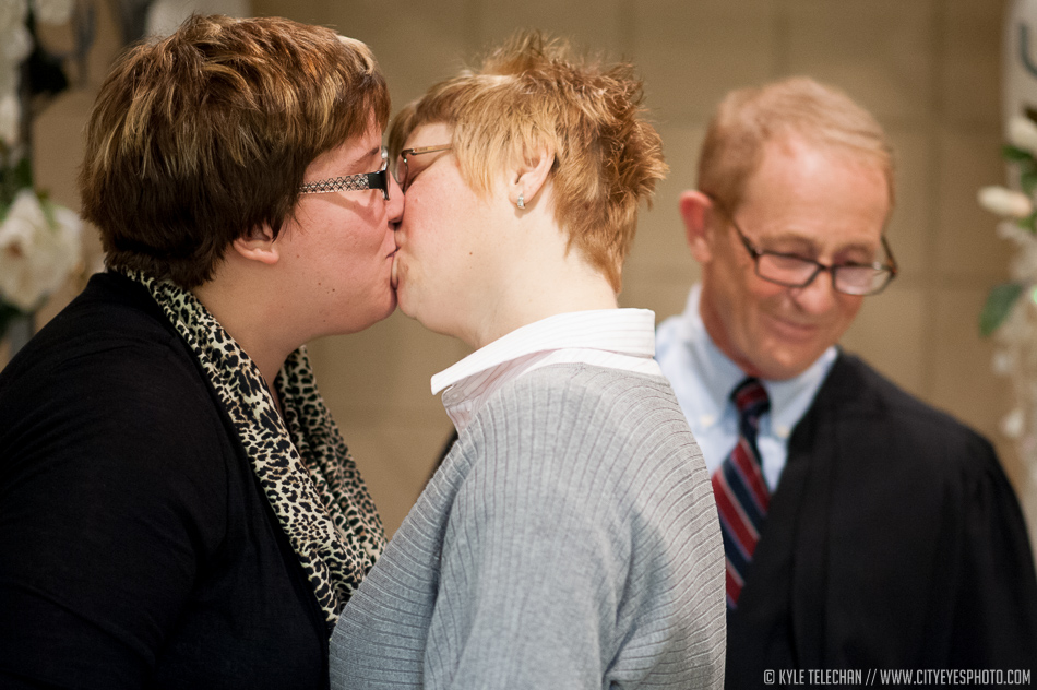 Hobart couple Michelle Davies, on left, and Tonya Richards kiss as Lake Superior Court judge John Pera stands near after performing their marriage ceremony on Tuesday at the Lake County Clerk's office. | Kyle Telechan/For Sun-Times Media
